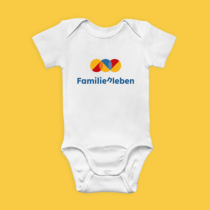 familienleben-strampler Ein freigestellter weißer Babybody mit dem Logo des Vereins
